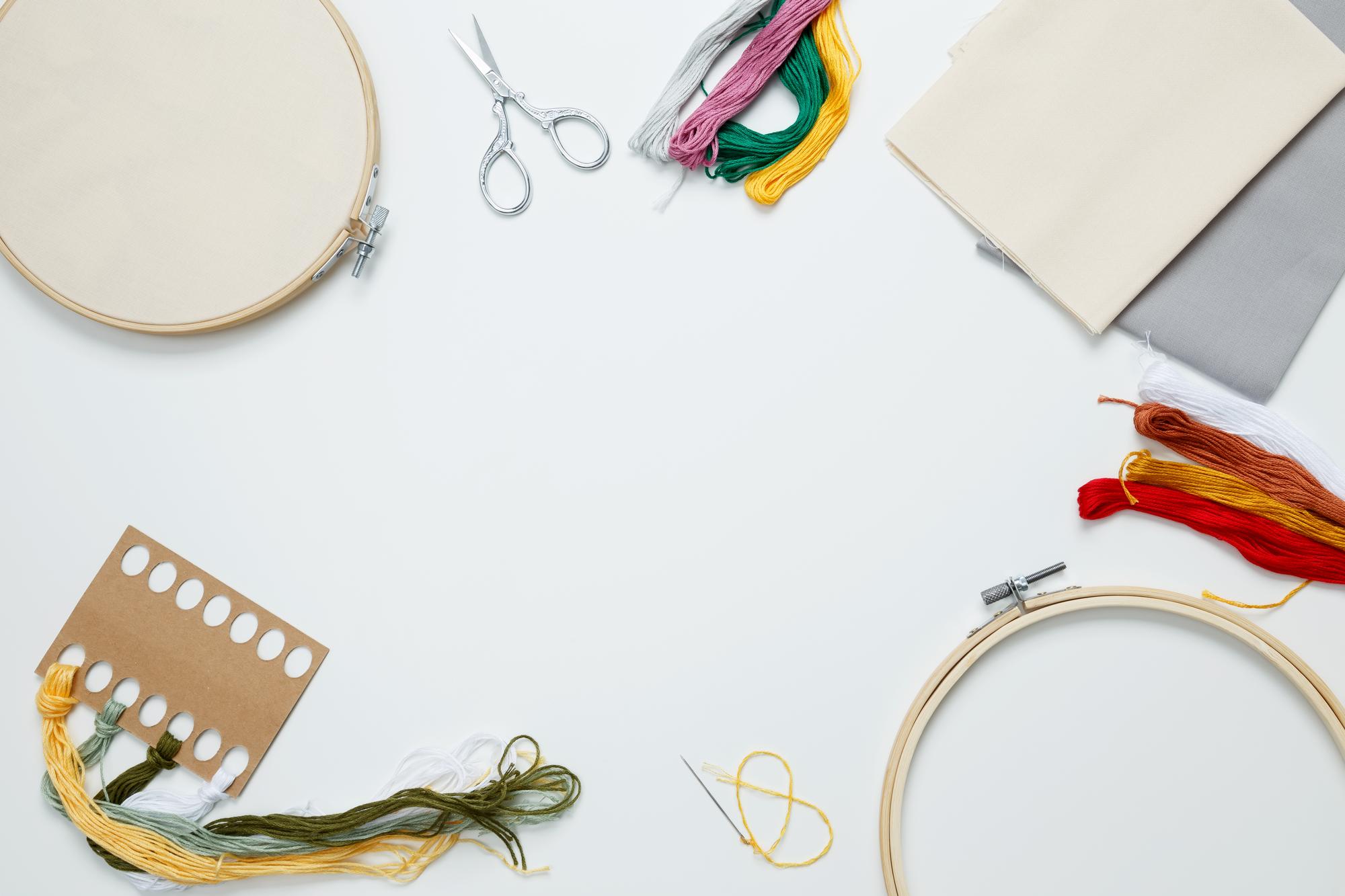Studio table with threads and embroidery hoops